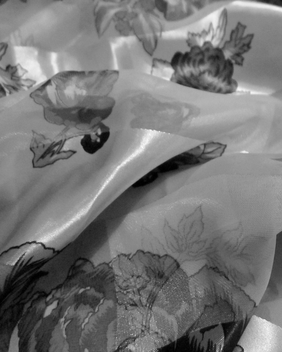 Close-up of soft folds of printed silk catching the light